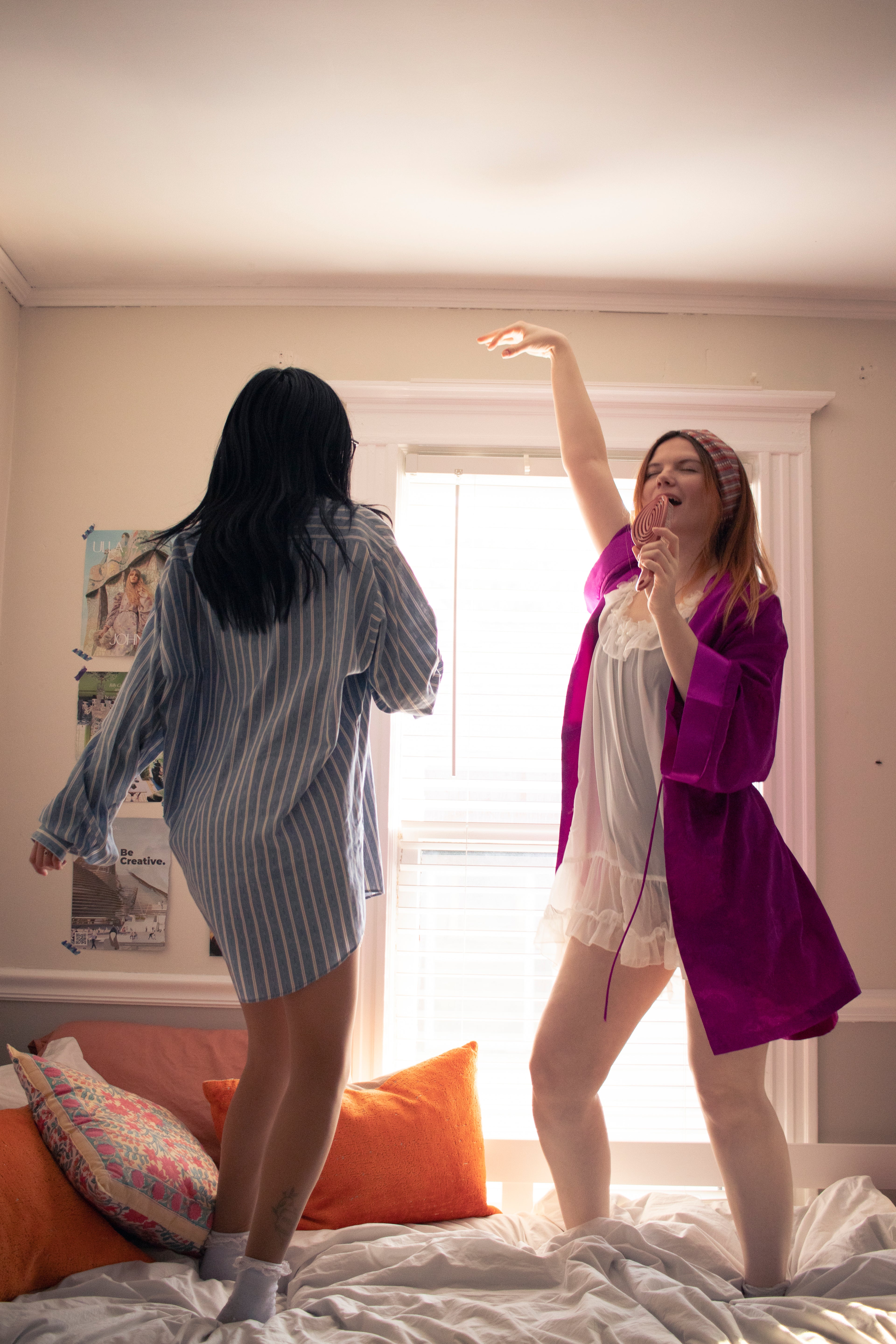 models sydney and katilyn wear the fulfilled pajama collection while jumping on a bed