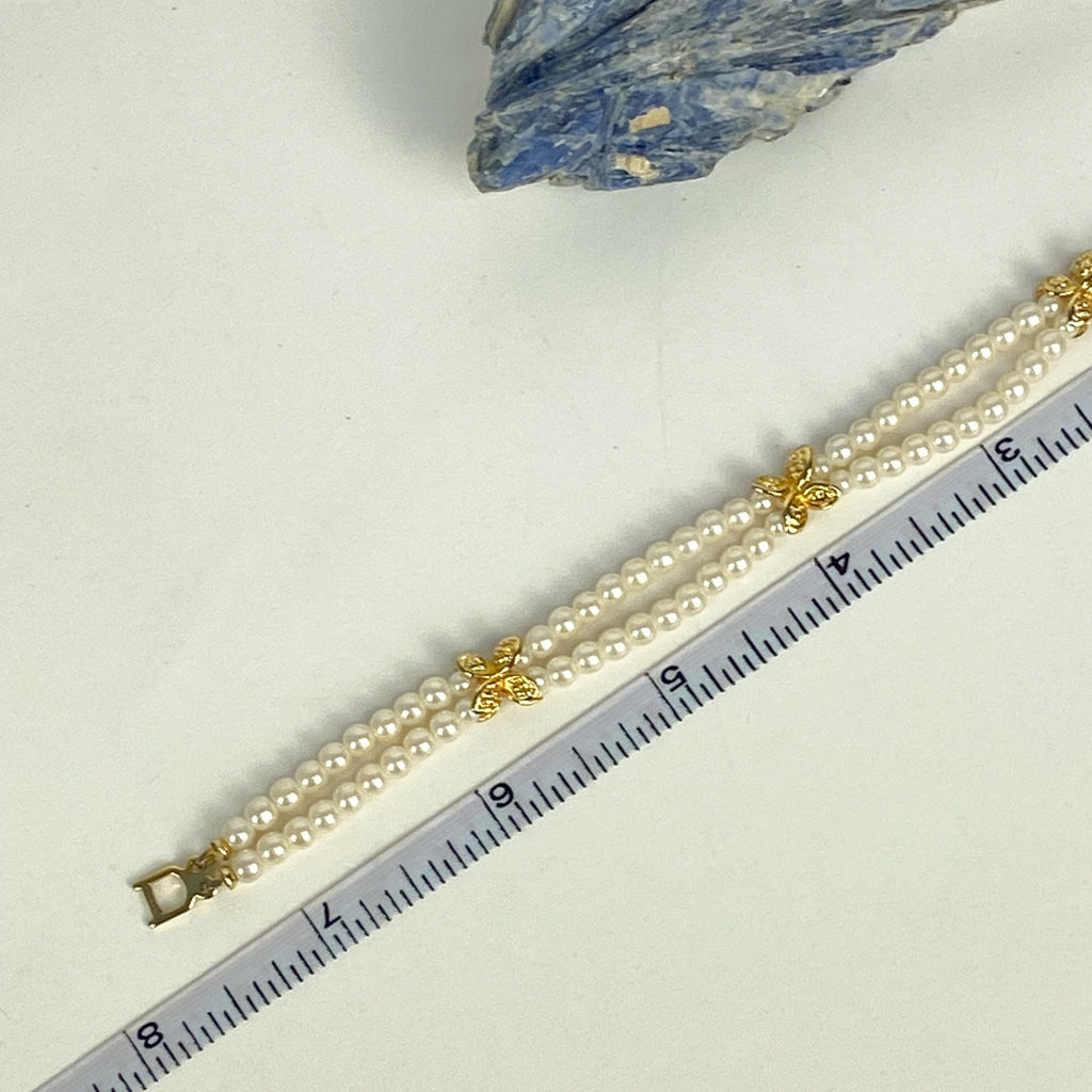Double Strand White and Gold Tone Beaded Bracelet.