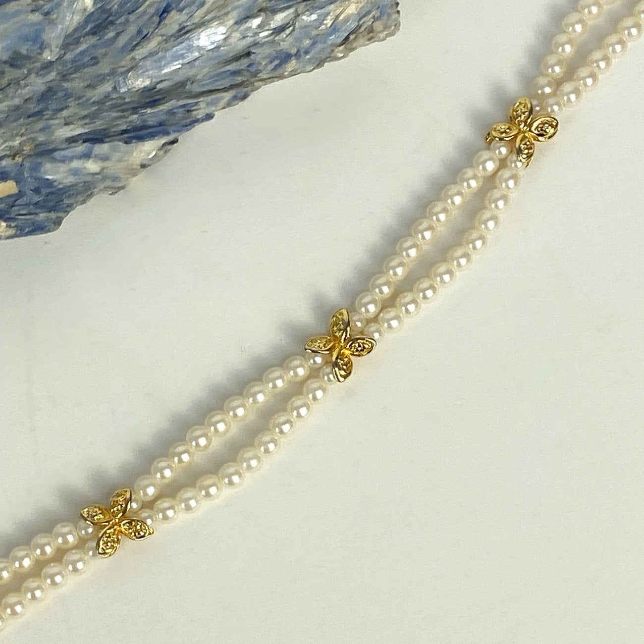 Double Strand White and Gold Tone Beaded Bracelet.