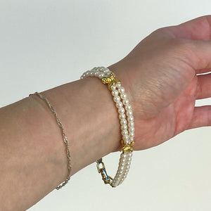 Double Strand White and Gold Tone Beaded Bracelet.