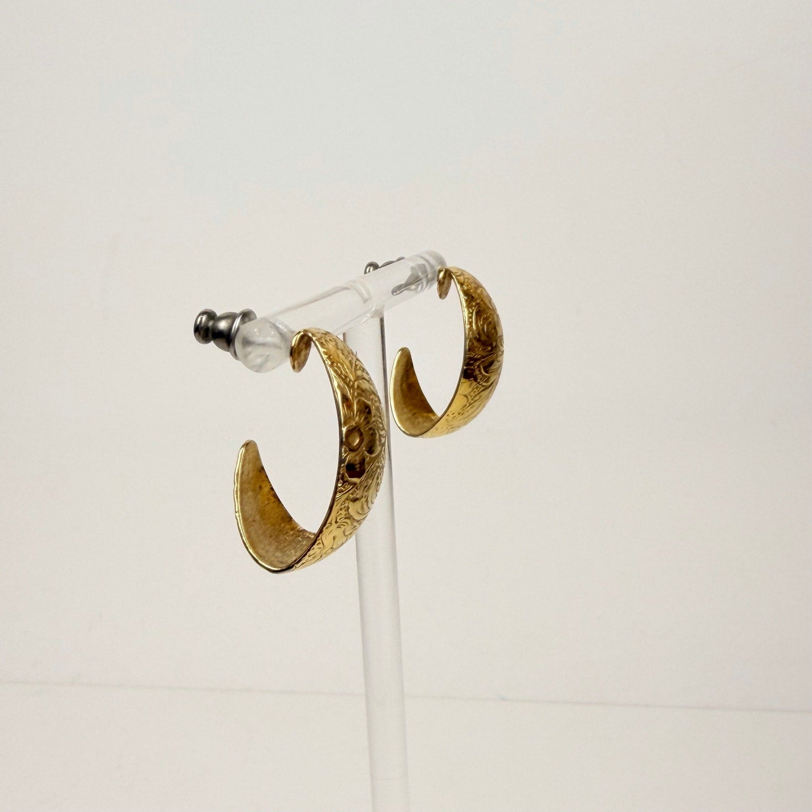 Gold tone floral design hoop earrings
