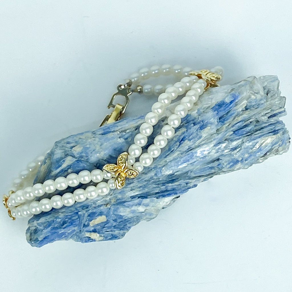 Double Strand White and Gold Tone Beaded Bracelet.